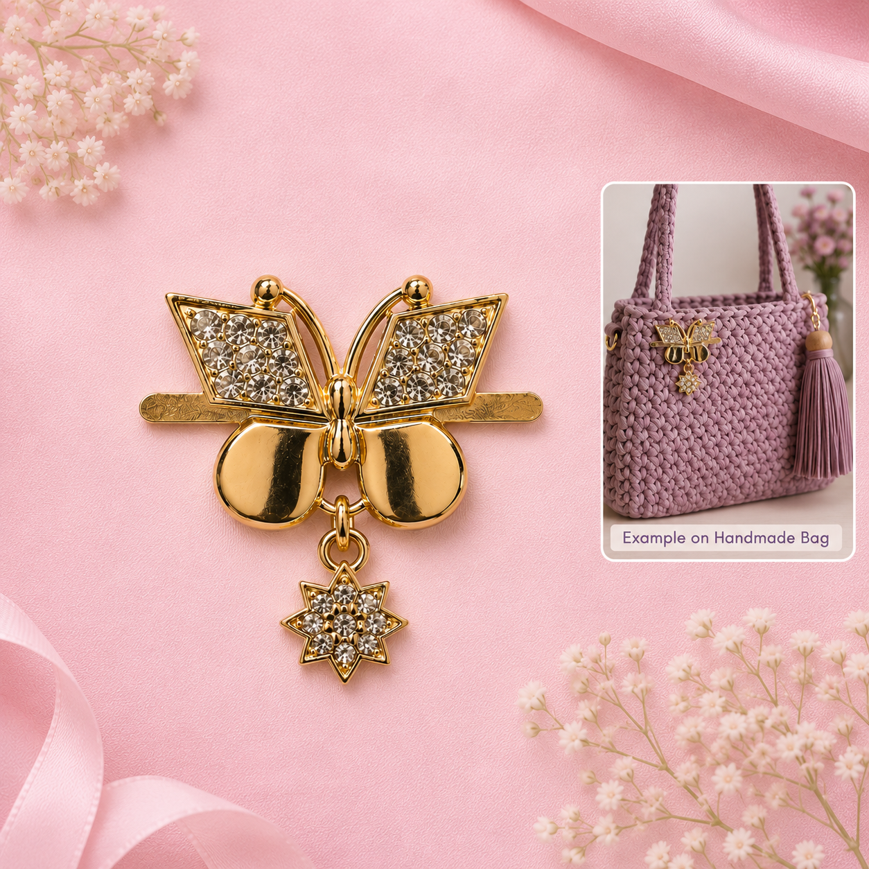 Gold butterfly-shaped brooch with crystal-embellished wings and a dangling crystal star charm, displayed on a pink satin background with decorative flowers. A small inset shows a lavender crocheted handbag with a matching butterfly charm.